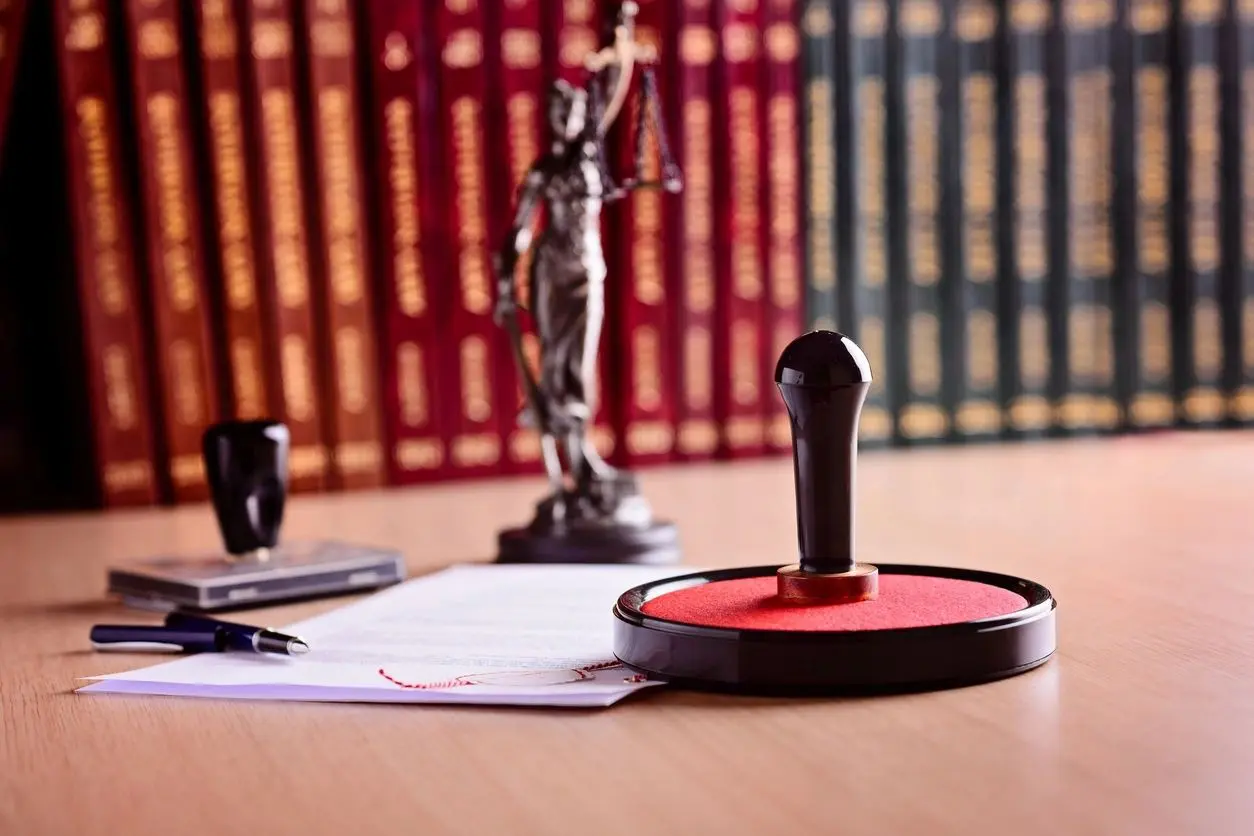 A microphone sitting on top of papers near a statue.