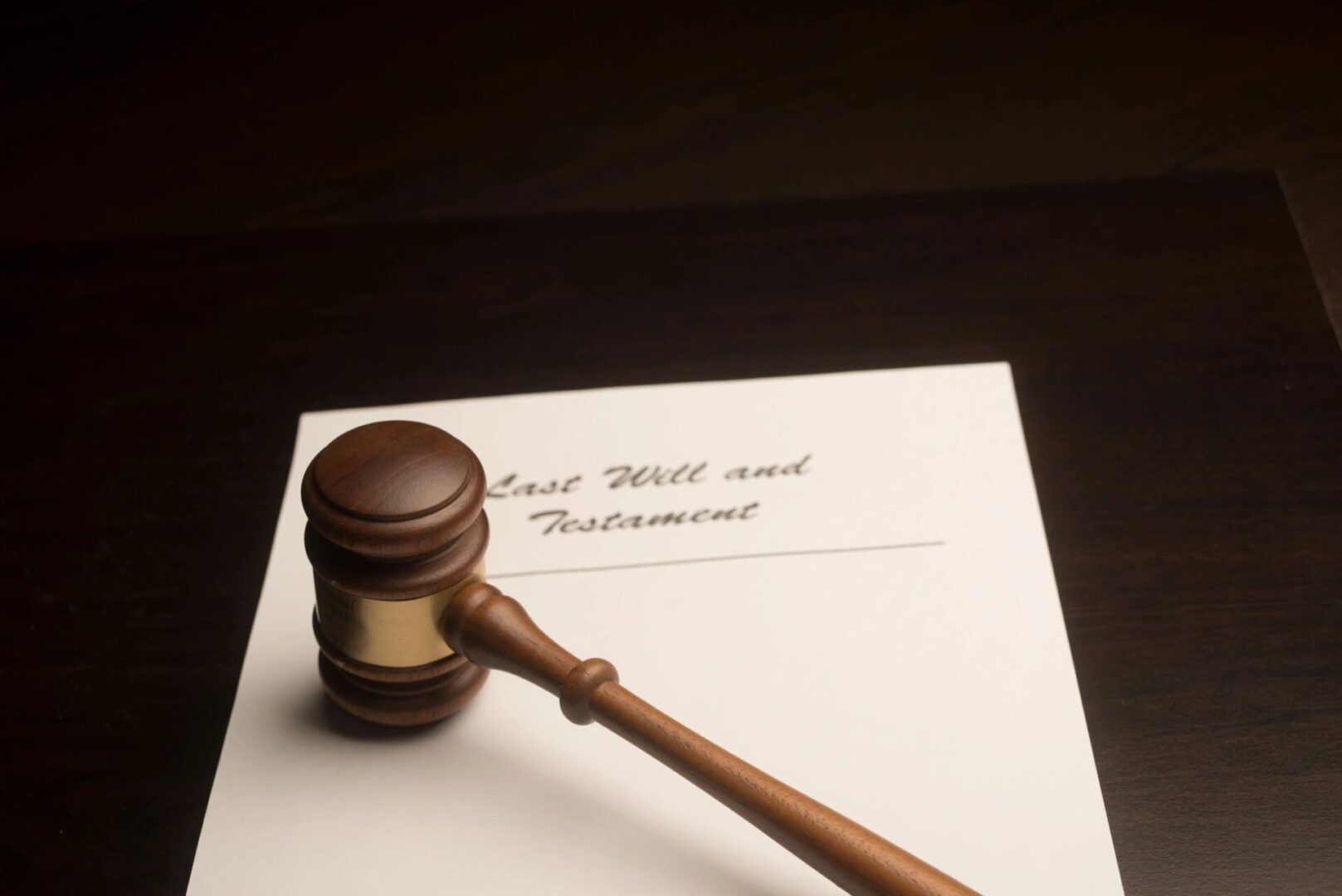 A wooden gavel sitting on top of a white paper.